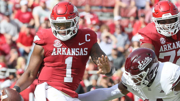 Razorbacks quarterback KJ Jefferson dodges a Mississippi State defender